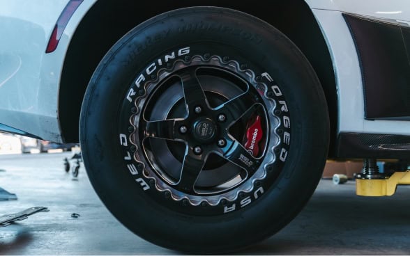 High-performance racing wheel with custom tire and brake system.