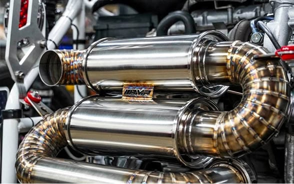 High-performance Black Market Racing exhaust system with polished metal finish.