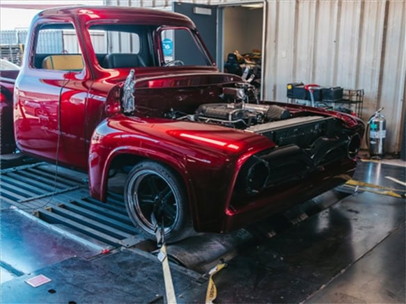 Candy red classic Ford pickup strapped down on the dyno at Black Market Racing