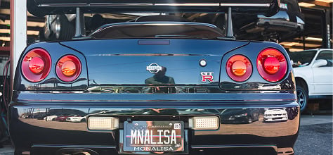 Black Nissan Skyline with custom license plate and racing modifications.