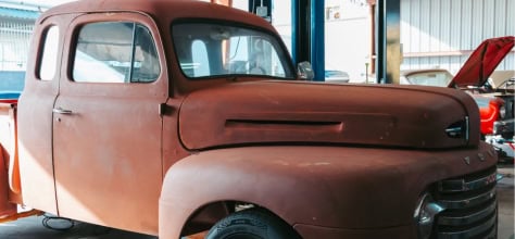 Vintage rusty truck with custom modifications for racing.