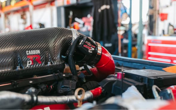 High-performance racing engine at Black Market Racing workshop.