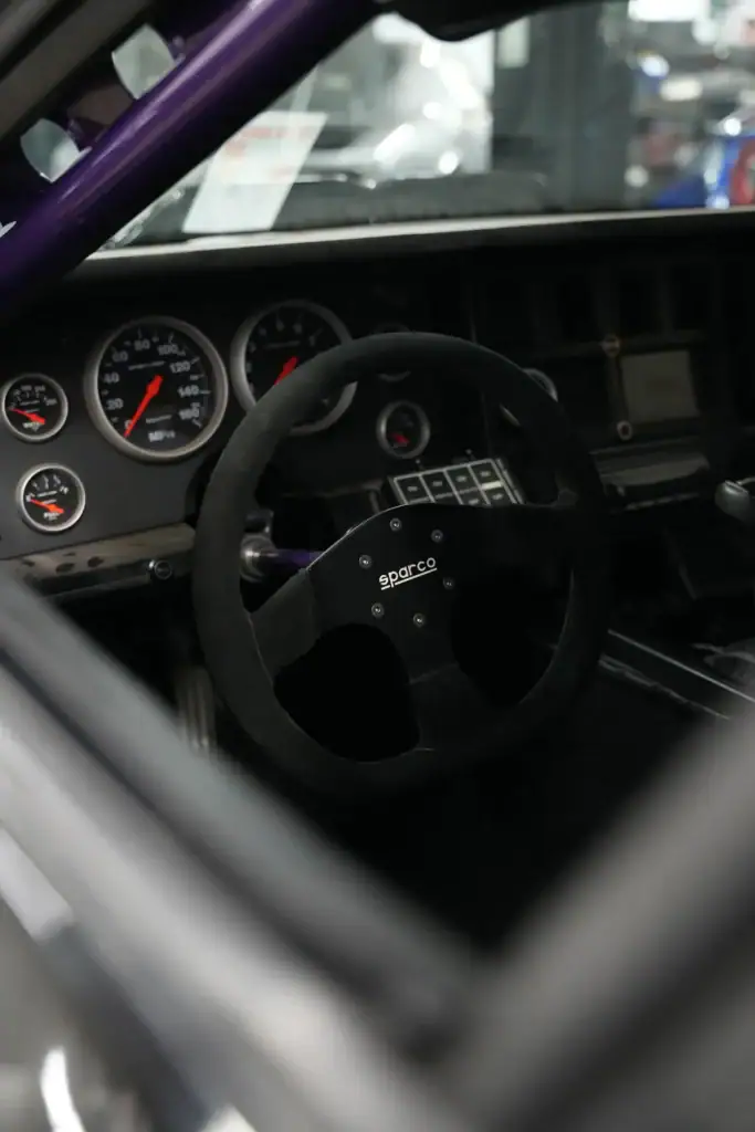 Close-up of racing car dashboard and steering wheel at Black Market Racing.