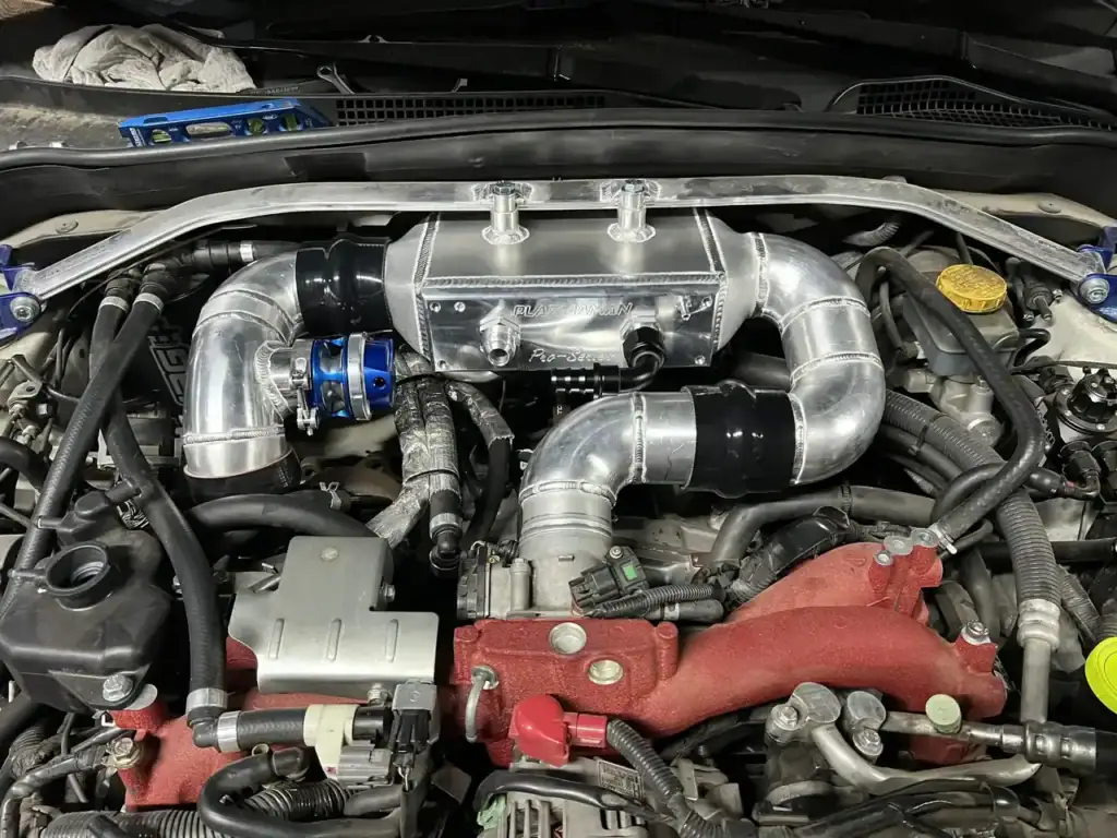 Subaru boxer engine with a top-mount intercooler and polished aluminium charge piping