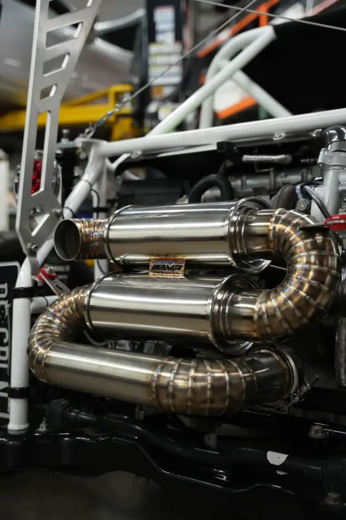 Custom automotive exhaust system with stainless steel pipes at Black Market Racing.