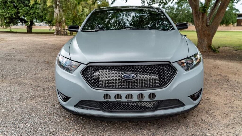Head-on view of a matte grey Ford Taurus SHO built by Black Market Racing