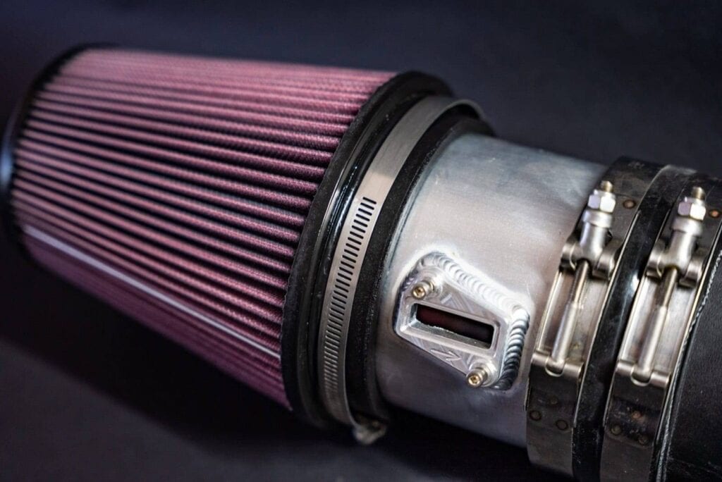 K&N cone filter clamped to a polished aluminium charge pipe with a welded sensor bung